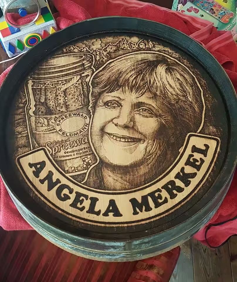 Commissioned pyrography portrait on a wooden barrel lid